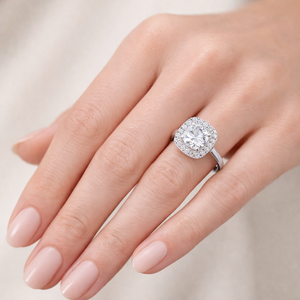 Cushion Halo Grace worn on hand in 18K Yellow Gold