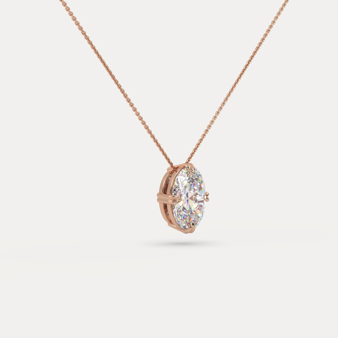 angled view of Solitaire Oval Cut Diamond Pendant in 18K Rose Gold