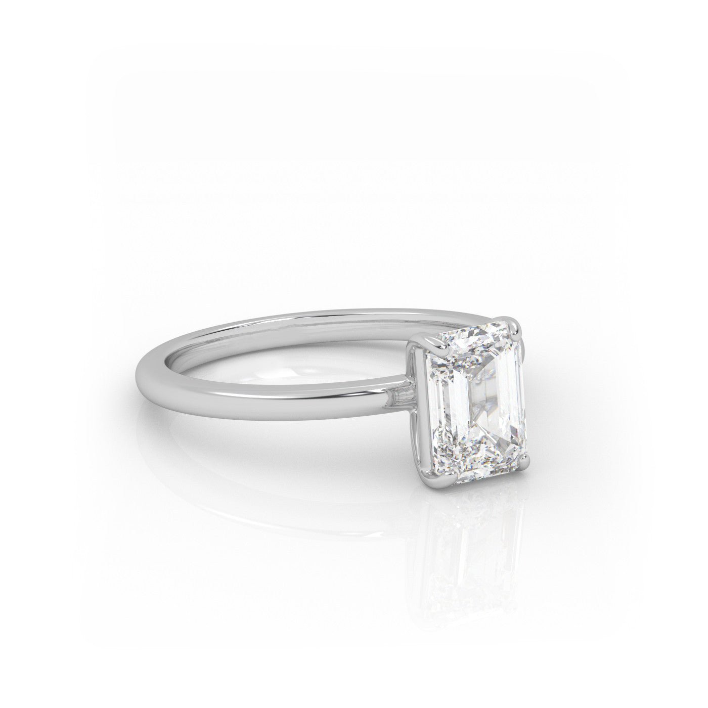 angled view of Solitaire Emerald Cut Diamond Ring in 18K White Gold