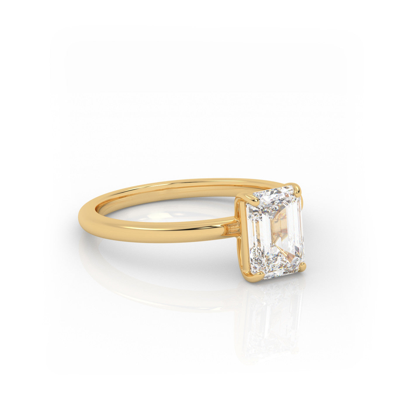 angled view of Solitaire Emerald Cut Diamond Ring in 18K Yellow Gold