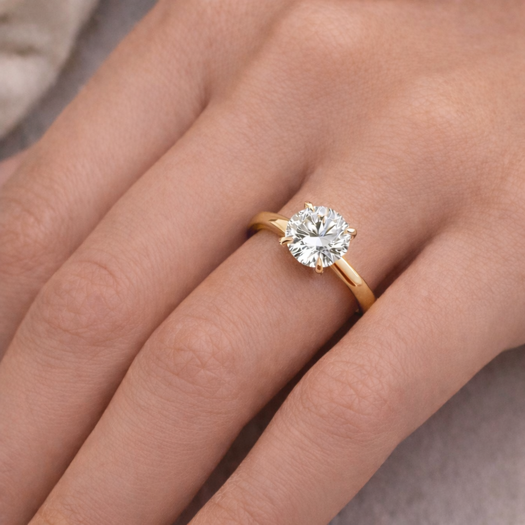 Solitaire Round Diamond Ring worn on hand in 18K Yellow Gold