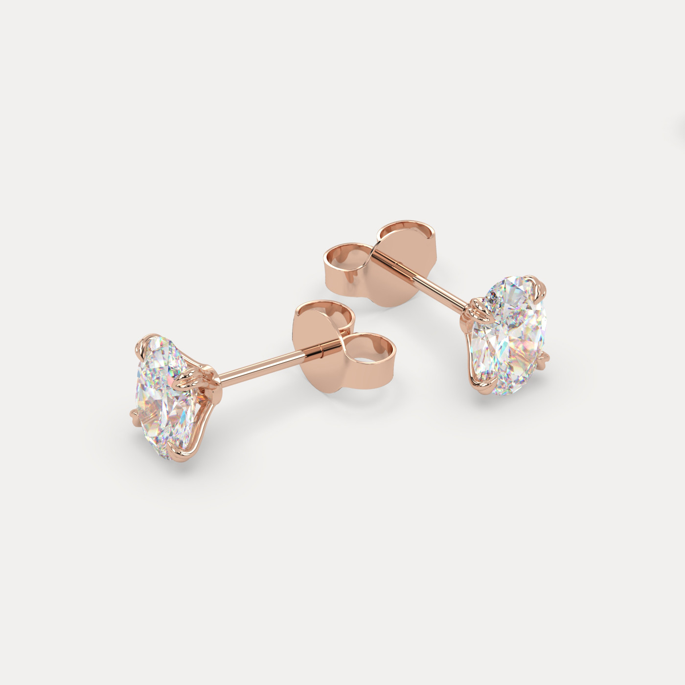 angled view of Oval Cut Diamond Stud Earrings in 18K Rose Gold