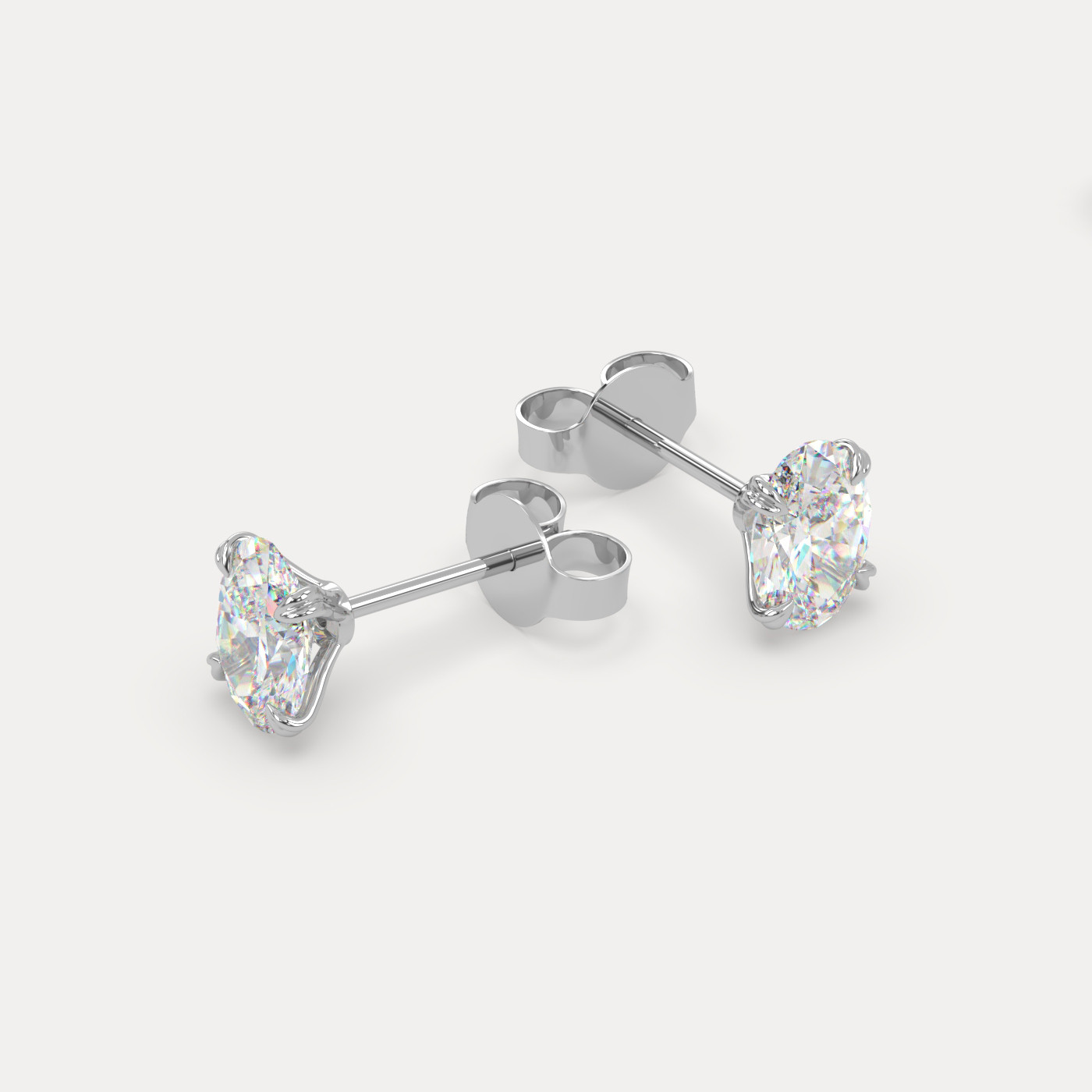 angled view of Oval Cut Diamond Stud Earrings in 18K White Gold