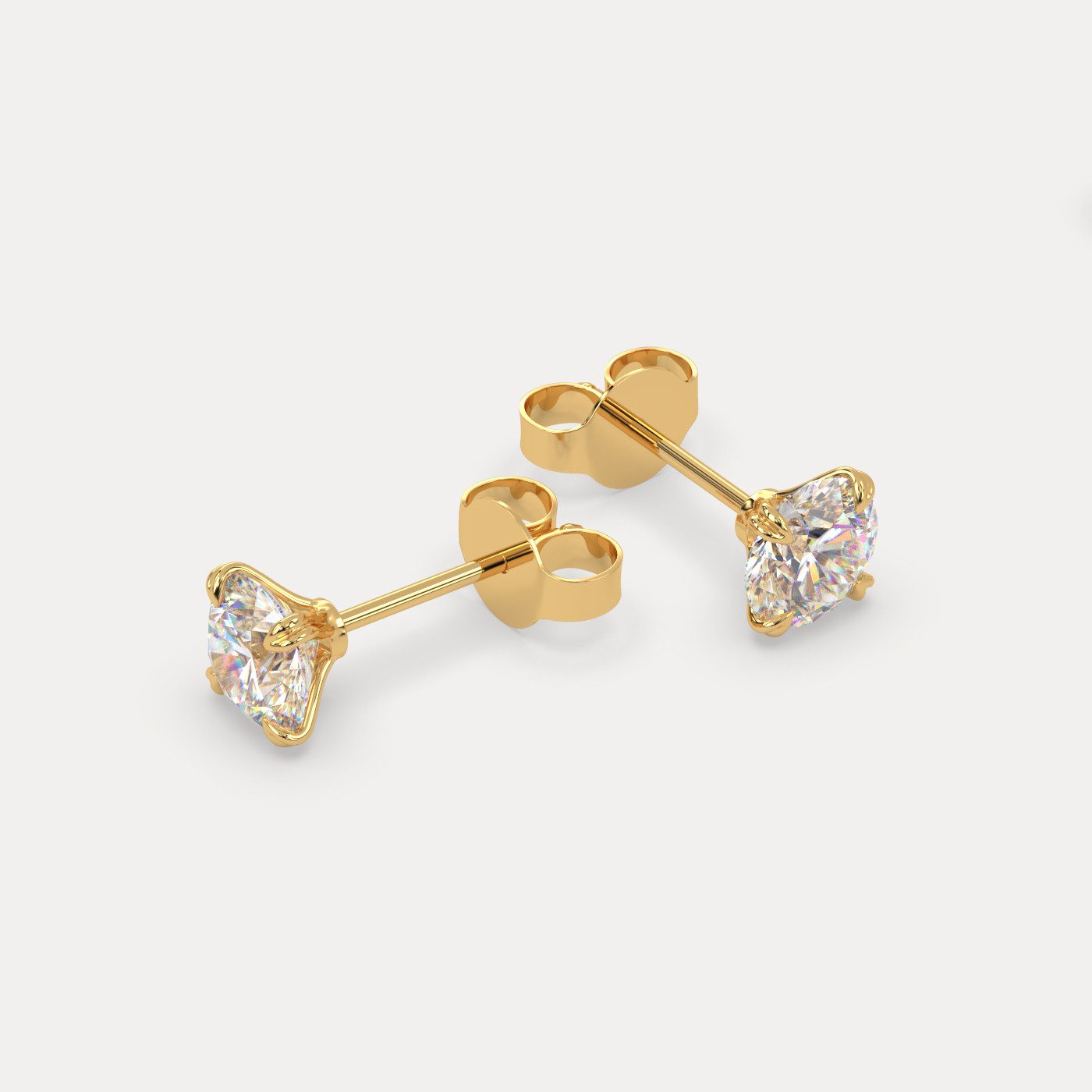 angled view of Round Cut Diamond Stud Earrings in 18K Yellow Gold