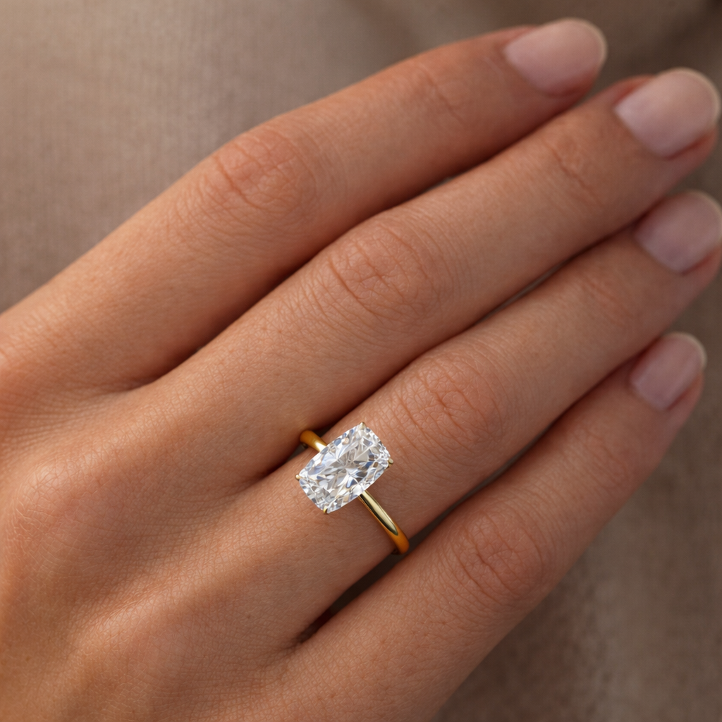 Solitaire Elongated Cushion Diamond Ring worn on hand in 18K Yellow Gold
